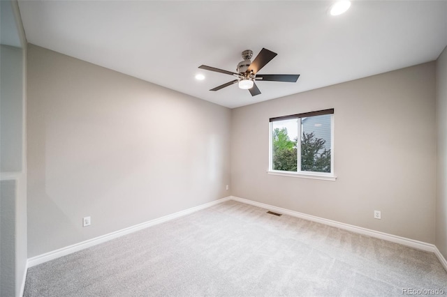 empty room featuring recessed lighting, baseboards, a ceiling fan, and light colored carpet