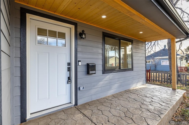 view of exterior entry with a porch