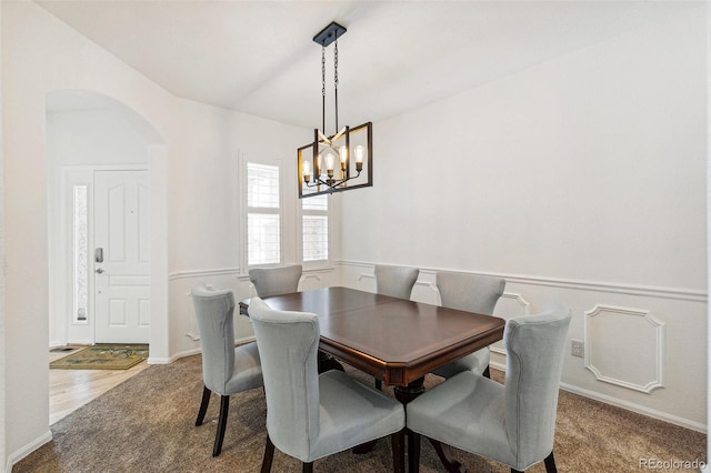 dining room featuring carpet flooring and a notable chandelier