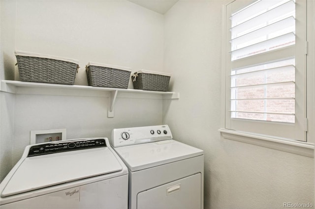 clothes washing area with washing machine and clothes dryer