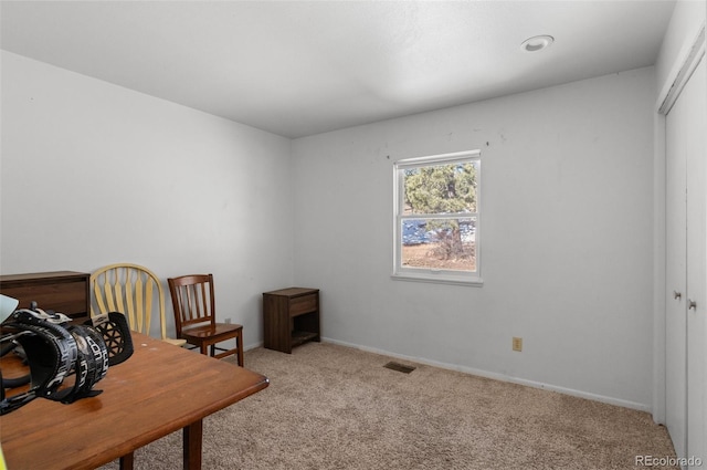 carpeted office with baseboards and visible vents