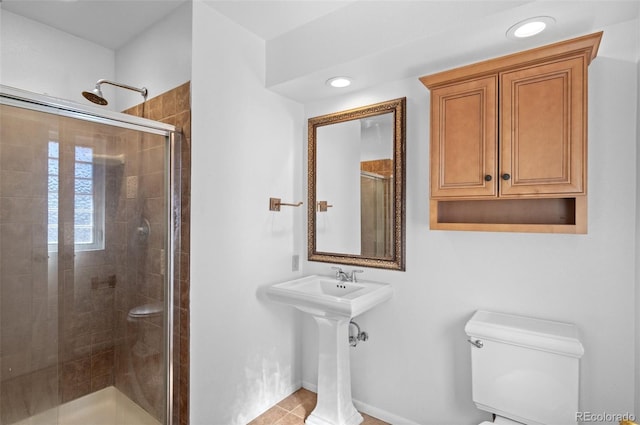 full bathroom featuring recessed lighting, baseboards, a shower stall, and toilet