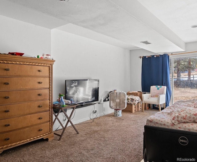 carpeted bedroom featuring visible vents, a textured ceiling, and baseboards