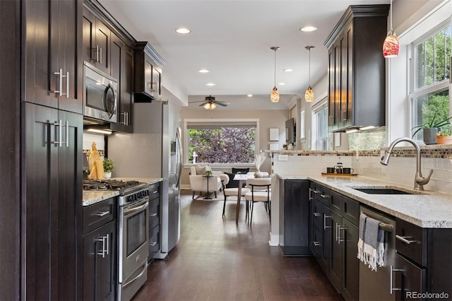 815 S Gaylord St, Denver, CO 80209 - kitchen with appliances with stainless steel finishes, dark wood-style floors, ceiling fan, decorative backsplash, and dark brown cabinets