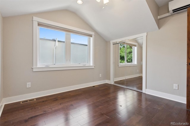 815 S Gaylord St, Denver, CO 80209 - additional living space with a wall unit AC, vaulted ceiling, and wood finished floors