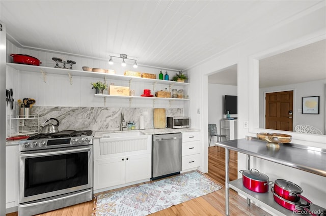 5465 Saulsbury Ct, Arvada, CO 80002 - kitchen with stainless steel appliances, open shelves, white cabinetry, and light wood-style floors