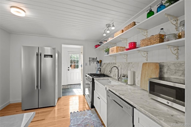 5465 Saulsbury Ct, Arvada, CO 80002 - kitchen with stainless steel appliances, open shelves, white cabinets, and light wood-style flooring