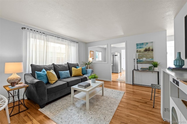 5465 Saulsbury Ct, Arvada, CO 80002 - living room with light wood-style flooring and a textured ceiling