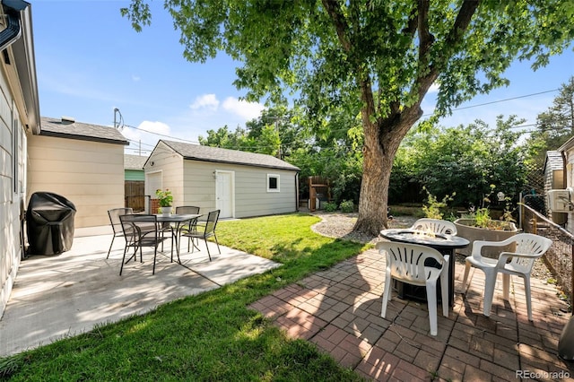 5465 Saulsbury Ct, Arvada, CO 80002 - view of patio with an outdoor fire pit, an outbuilding, and grilling area