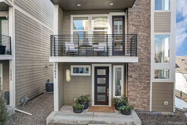 doorway to property with a balcony and central AC