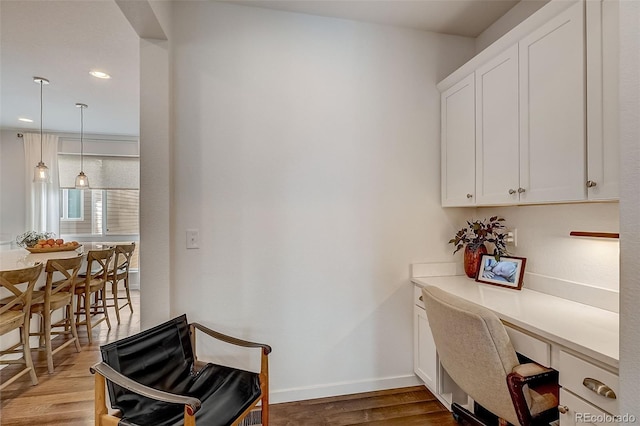 office area with built in desk and light hardwood / wood-style floors