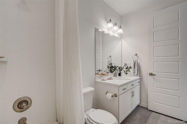 bathroom featuring tile patterned flooring, vanity, and toilet