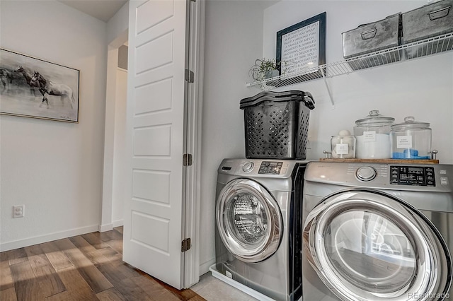 washroom featuring washer and clothes dryer and wood-type flooring