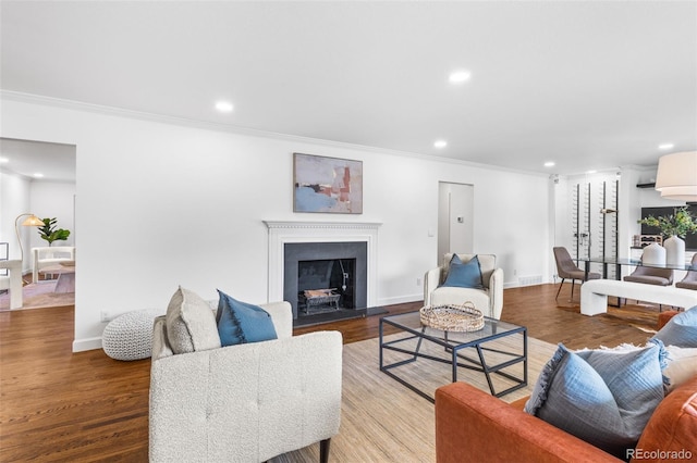 living room with hardwood / wood-style floors and crown molding