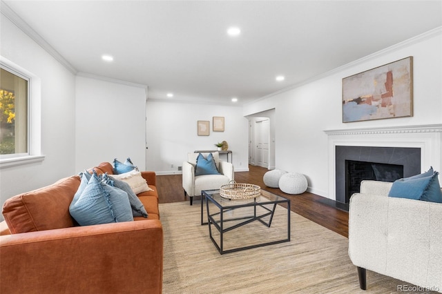 living room with hardwood / wood-style flooring and ornamental molding