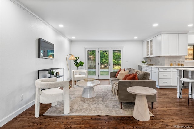 living room featuring crown molding, dark hardwood / wood-style floors, and french doors