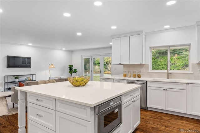 kitchen featuring white cabinetry, appliances with stainless steel finishes, dark hardwood / wood-style flooring, and sink