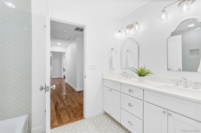 bathroom featuring vanity and a washtub