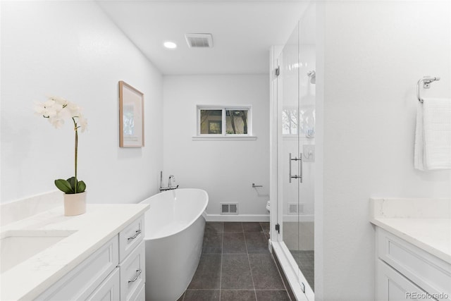 full bathroom featuring vanity, tile patterned floors, toilet, and separate shower and tub