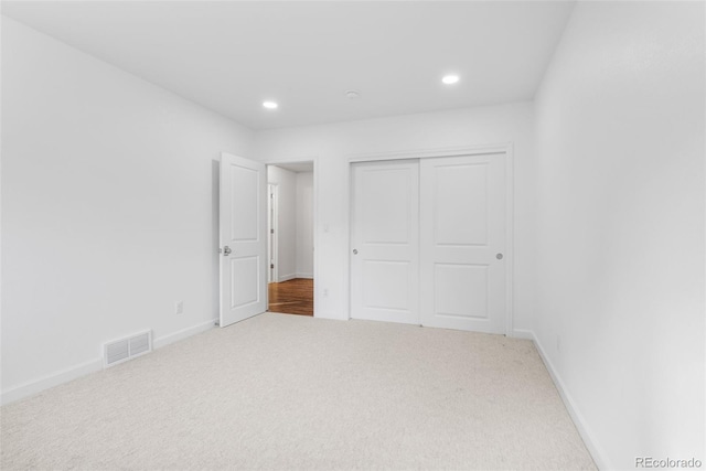 unfurnished bedroom featuring carpet floors and a closet