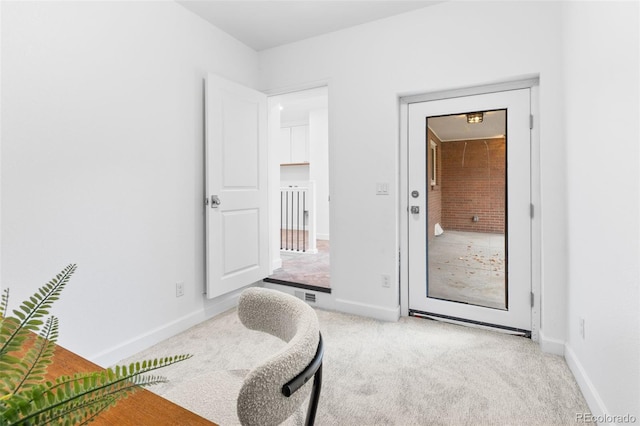 sitting room featuring light colored carpet