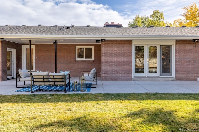 rear view of house featuring a patio, outdoor lounge area, and a yard