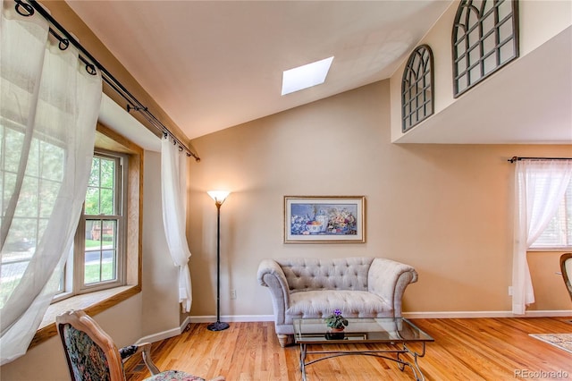 6687 Devinney Ct, Arvada, CO 80004 - sitting room featuring a skylight, wood finished floors, baseboards, and lofted ceiling