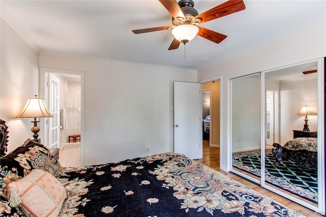 6687 Devinney Ct, Arvada, CO 80004 - bedroom with wood finished floors, ornamental molding, a ceiling fan, a closet, and baseboards