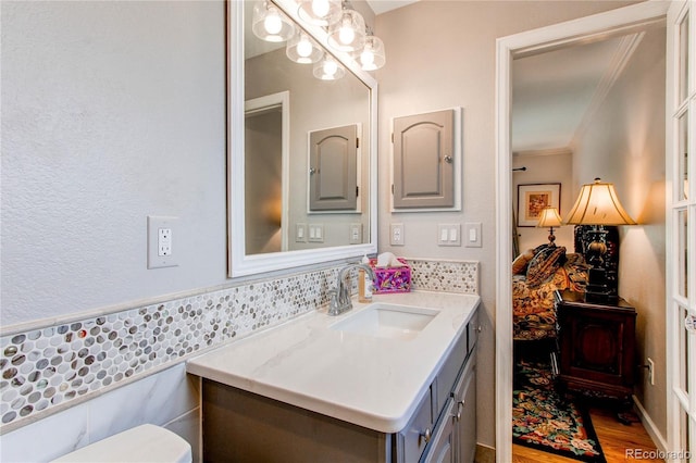 6687 Devinney Ct, Arvada, CO 80004 - bathroom with vanity, ornamental molding, and wood finished floors