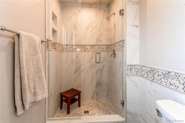 6687 Devinney Ct, Arvada, CO 80004 - full bathroom with a stall shower, toilet, and tile walls
