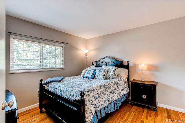 6687 Devinney Ct, Arvada, CO 80004 - bedroom with baseboards and wood finished floors