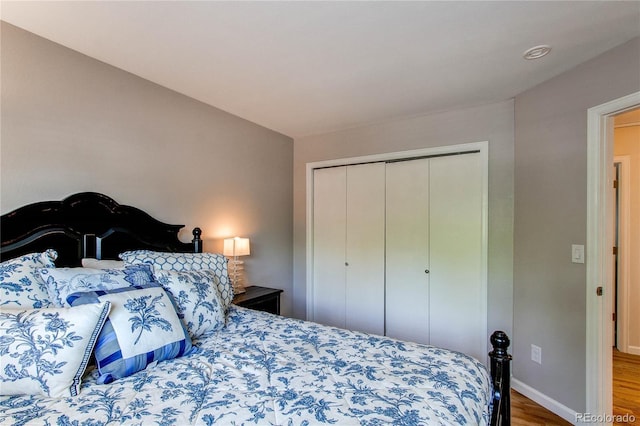 6687 Devinney Ct, Arvada, CO 80004 - bedroom with wood finished floors, a closet, and baseboards