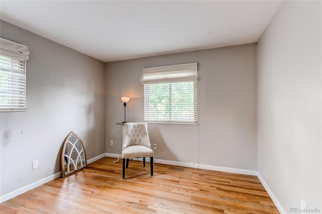 6687 Devinney Ct, Arvada, CO 80004 - living area featuring light wood-type flooring and baseboards