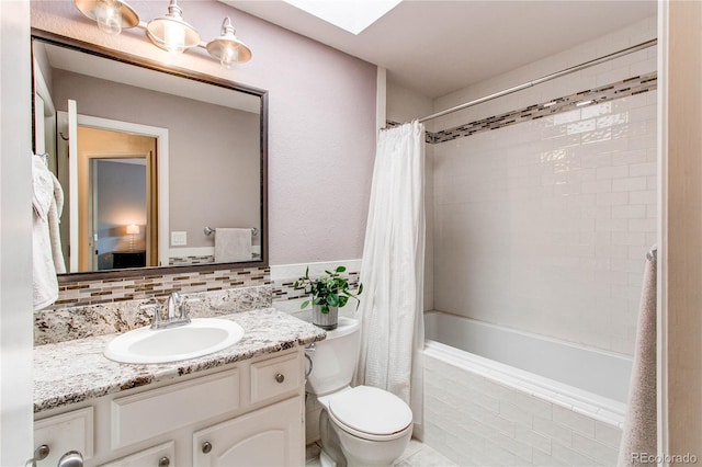 6687 Devinney Ct, Arvada, CO 80004 - bathroom featuring vanity, a skylight, tiled shower / bath, and toilet