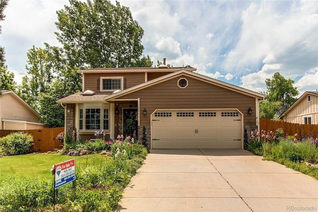 6687 Devinney Ct, Arvada, CO 80004 - traditional home featuring stone siding, concrete driveway, and a garage