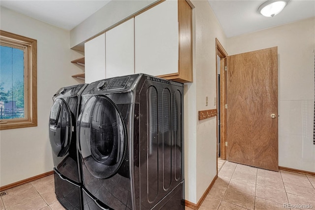 clothes washing area with washer and clothes dryer and light tile patterned floors