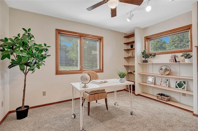 carpeted home office featuring ceiling fan and plenty of natural light