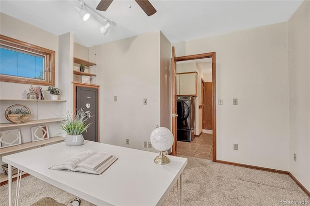 office space featuring washer / clothes dryer, ceiling fan, and light colored carpet