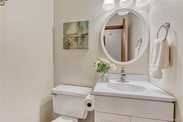 bathroom with toilet and vanity