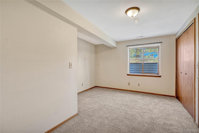 unfurnished bedroom with a closet and carpet