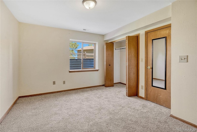 unfurnished bedroom featuring light carpet