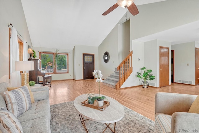 living room with high vaulted ceiling, ceiling fan, and wood-type flooring