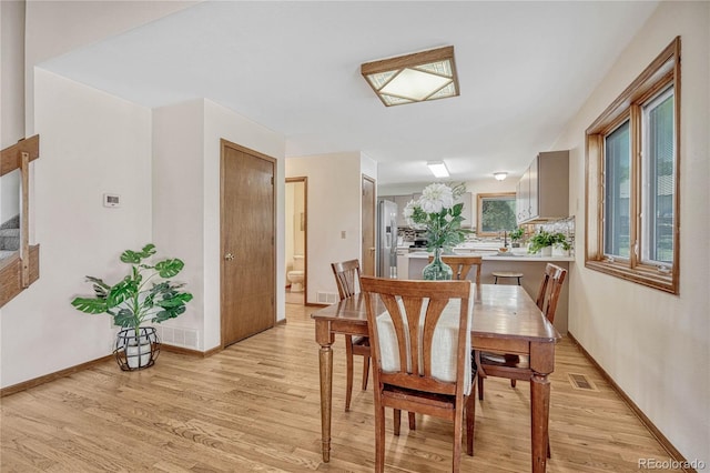 dining area with light hardwood / wood-style flooring