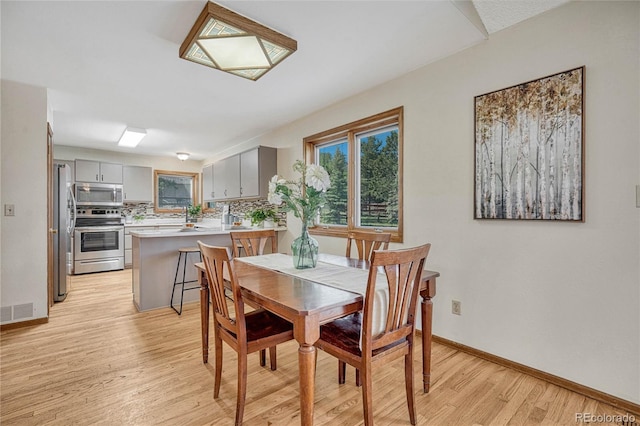 dining area with light hardwood / wood-style floors