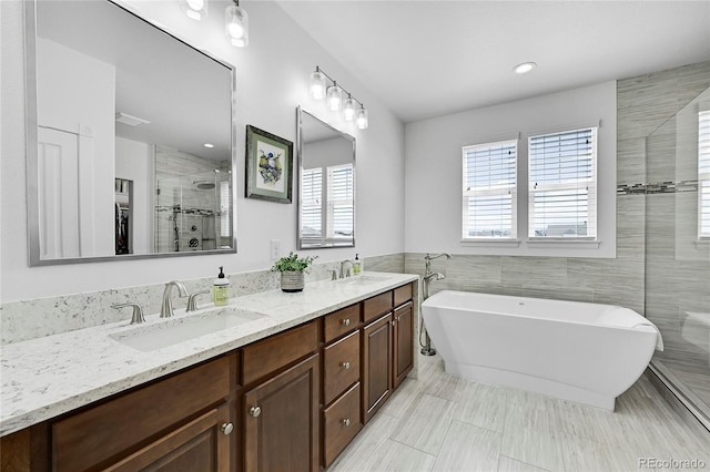 bathroom with vanity, plus walk in shower, and tile walls