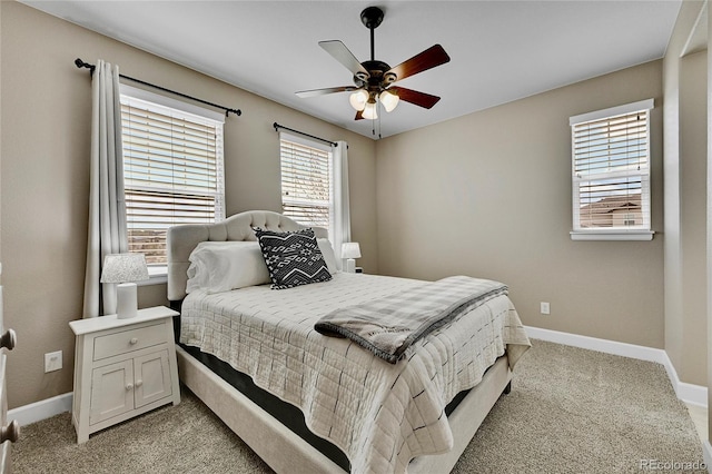 carpeted bedroom with ceiling fan and multiple windows