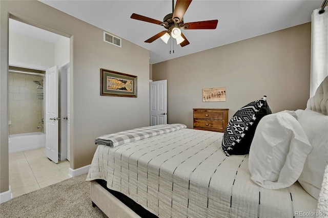 bedroom featuring connected bathroom, ceiling fan, and light tile patterned flooring