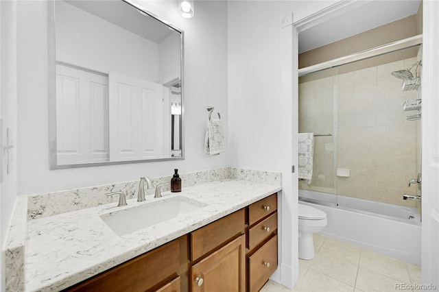 full bathroom featuring tile patterned flooring, vanity, shower / bath combination with glass door, and toilet