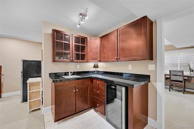 kitchen featuring wine cooler, light colored carpet, stainless steel fridge, and sink