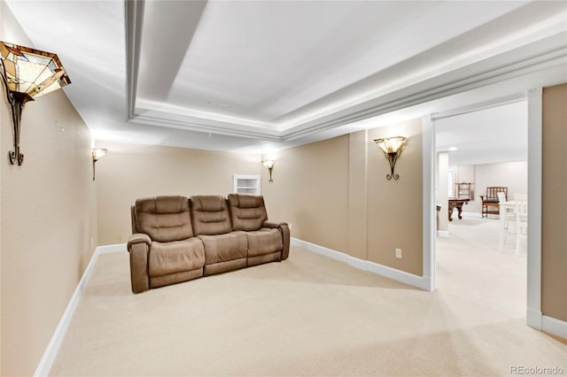 home theater room with a tray ceiling and carpet